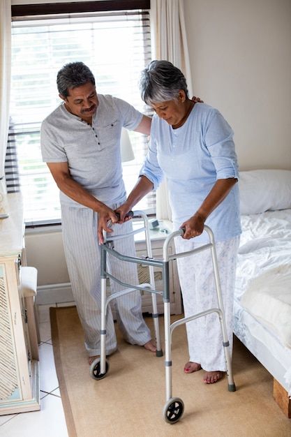 Senior man helping senior woman with healthcare
